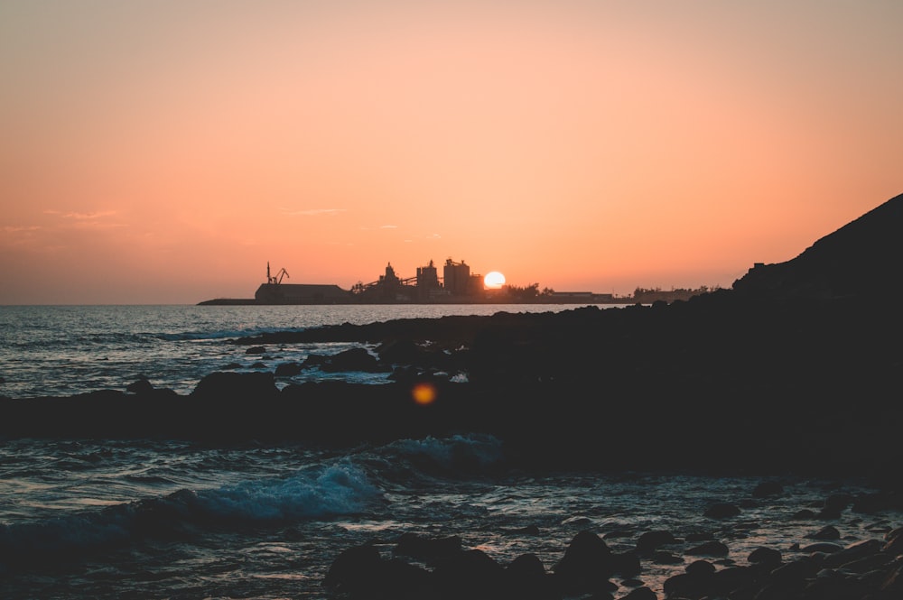 silhouette of people on beach during sunset