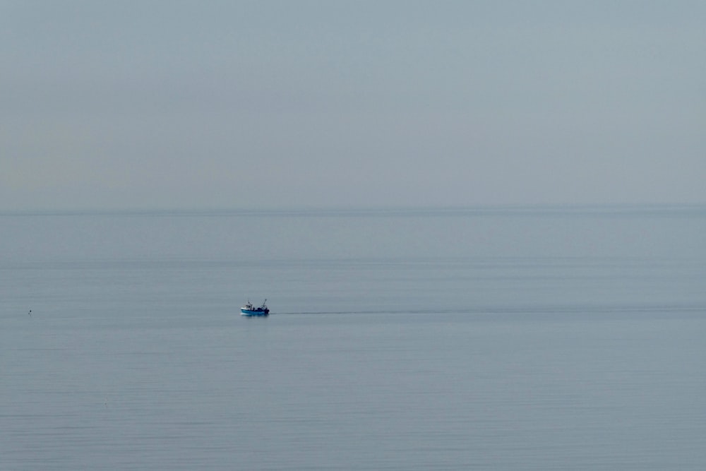 person riding on boat on sea during daytime