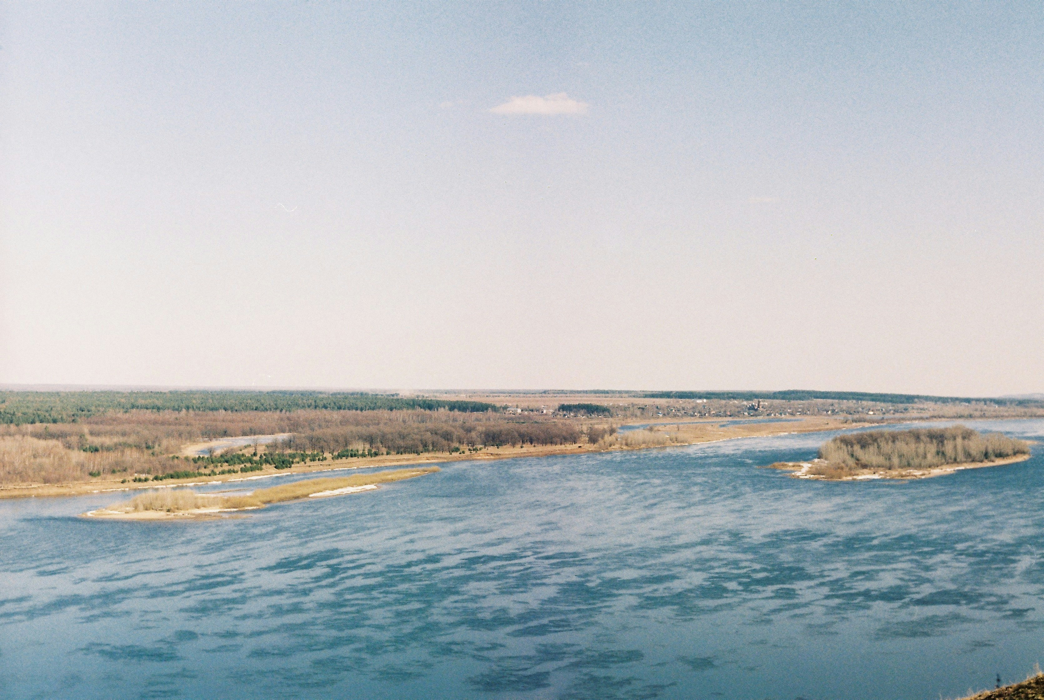 #art.ilya Сamera roll Kodak. A wide river with an island in the middle, blue sky, blue water. Early spring, sunny day. Minimalism, Perfectionist Paradise.