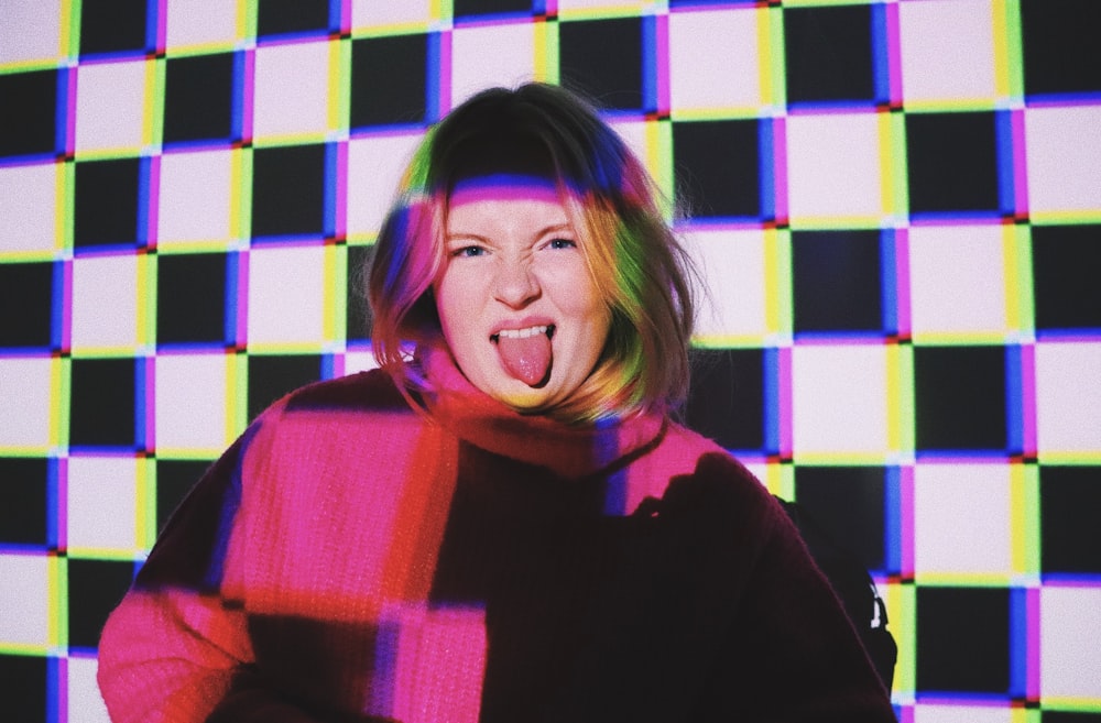 woman in black and purple sweater smiling