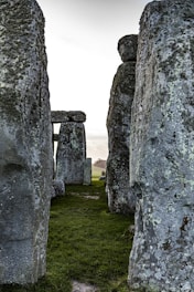 gray rock formation on green grass field during daytime