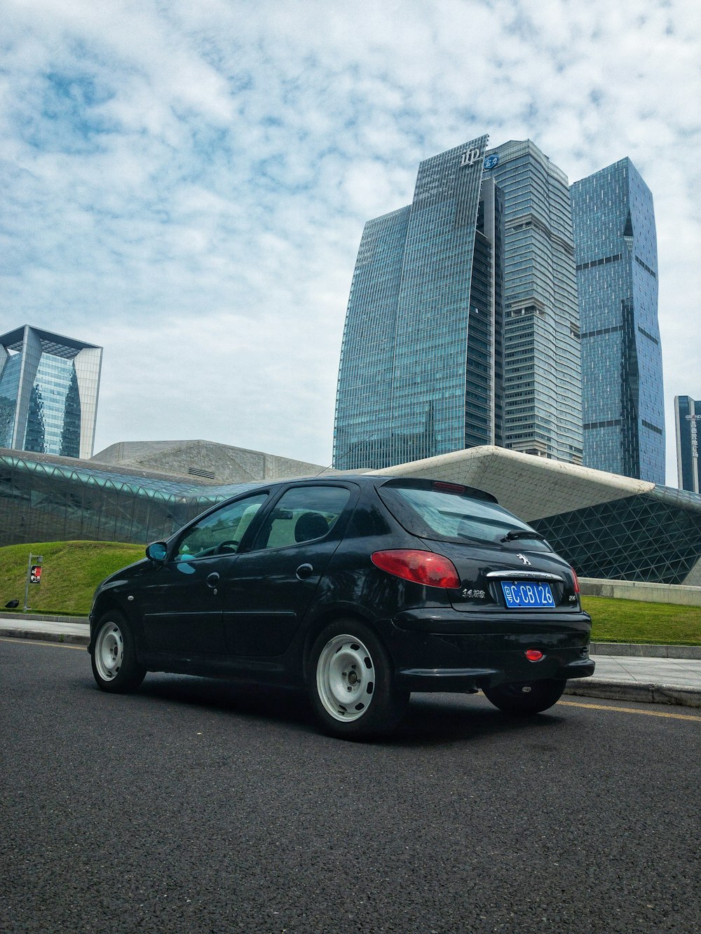 black sedan parked near building during daytime