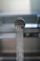 Close-up of a modern kitchen faucet with water flowing smoothly.