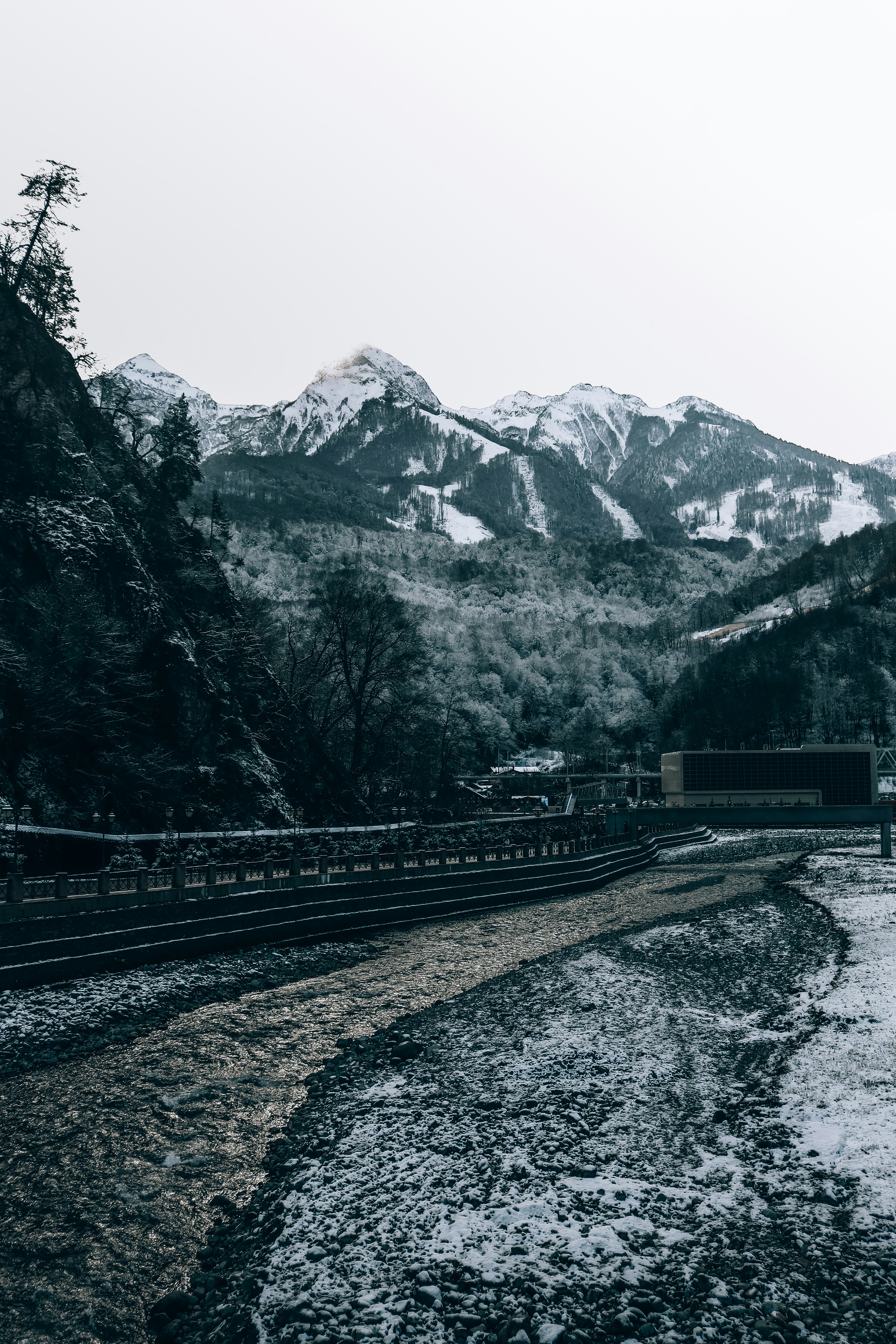 black train rail near brown and white mountains during daytime