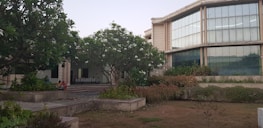 Calm hospital entrance surrounded by greenery, inviting and peaceful.