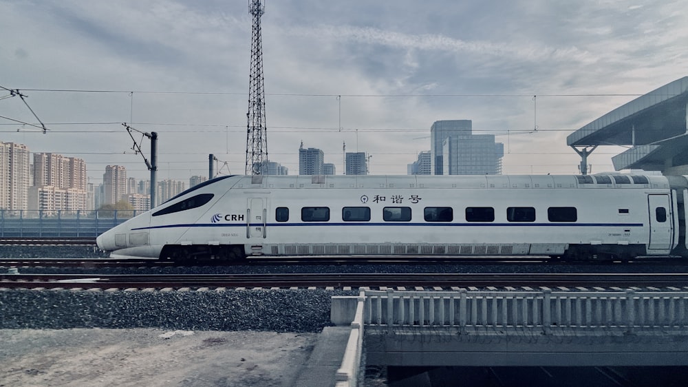 white and blue train on rail during daytime