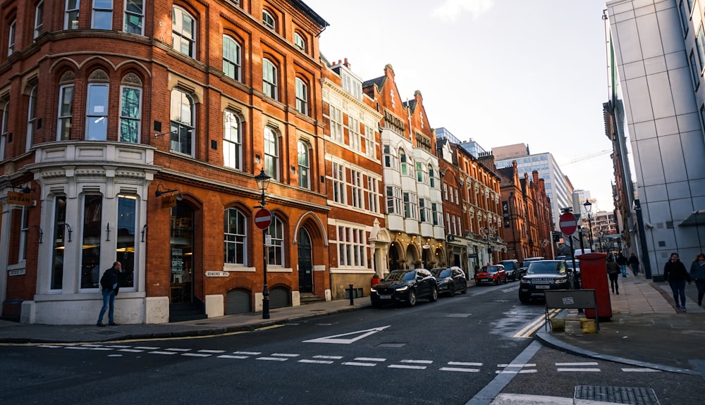 cars parked in front of brown building during daytime