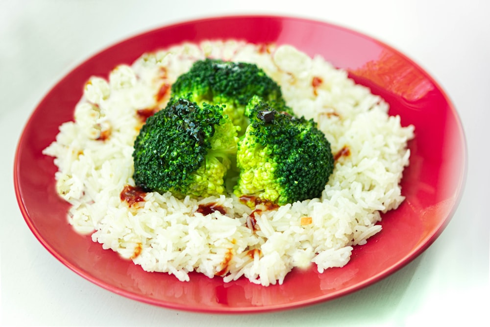 white rice with green broccoli on red plate