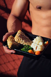 Sporty person enjoying a high-protein meal from a meal prep box