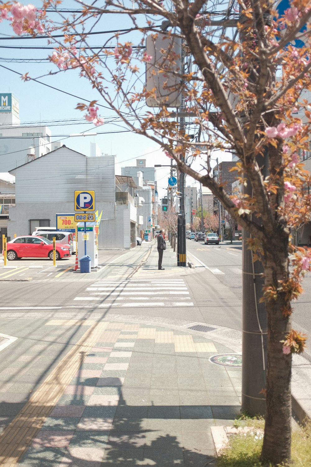 red car on road near building during daytime