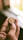 Close-up of hands examining a vintage coin under soft natural light.
