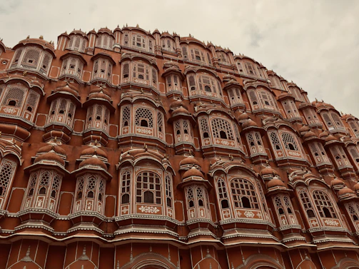 Elegant red sandstone townhouse with intricate architectural details.