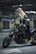 woman in black leather jacket riding black cruiser motorcycle