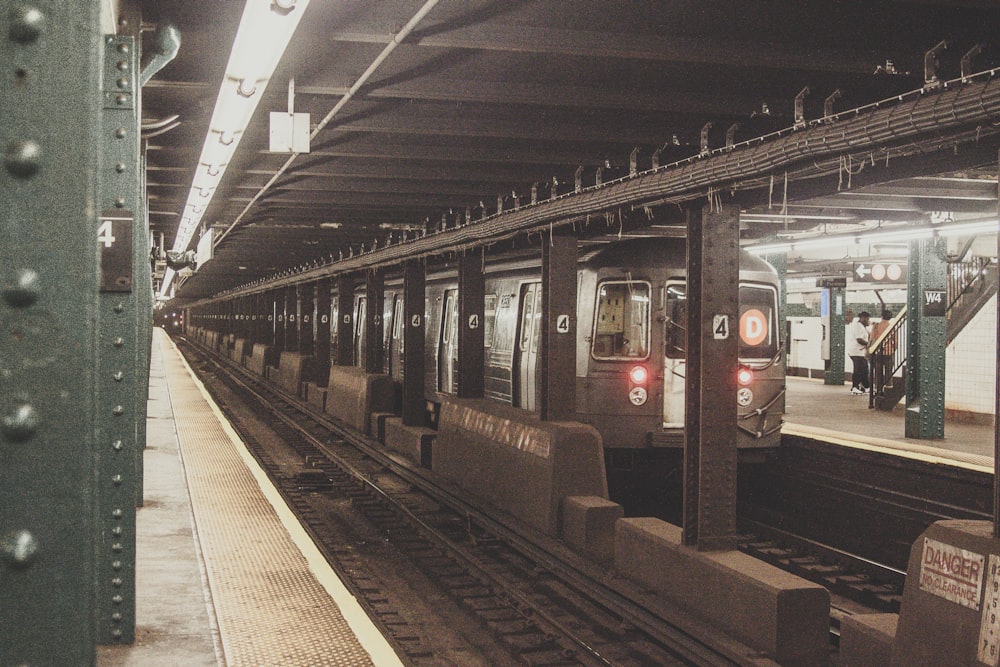 black and red train in train station