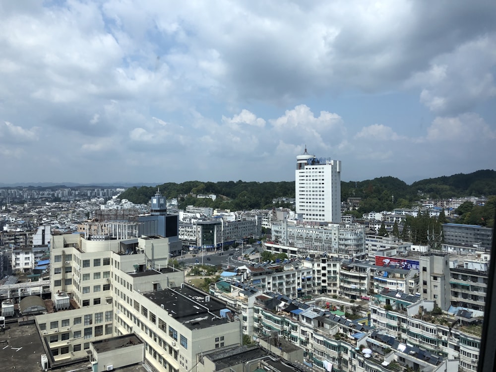 city buildings under white clouds during daytime