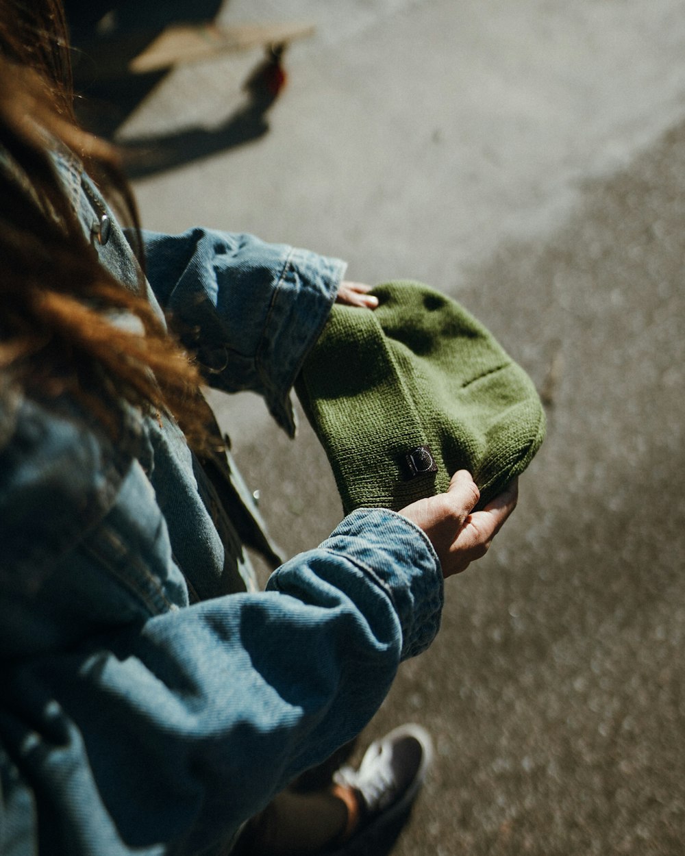 woman in green sweater and blue denim jeans