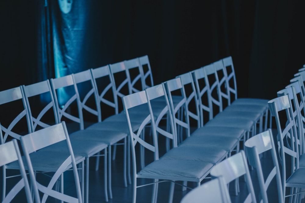 white wooden chair near red curtain