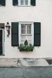 black wooden window on white concrete building during daytime