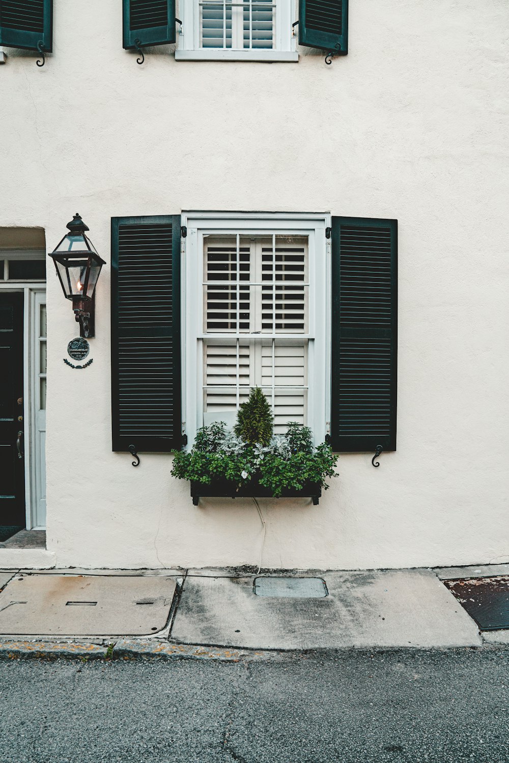 black wooden window on white concrete building during daytime