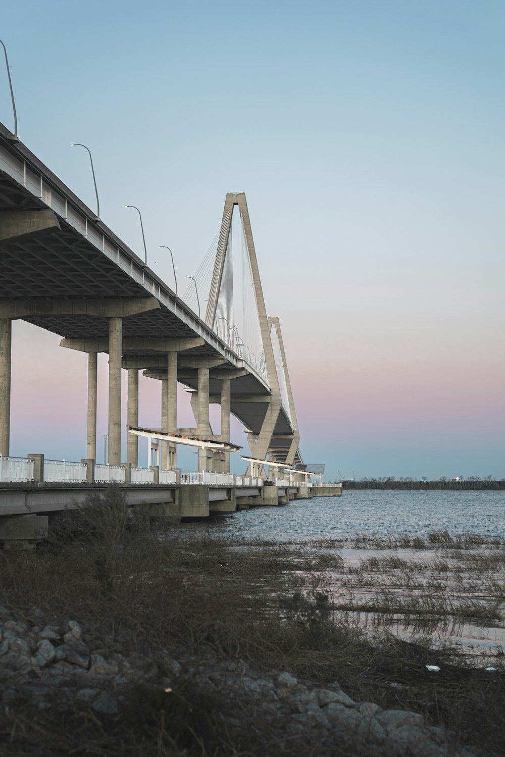 white bridge over the sea during daytime