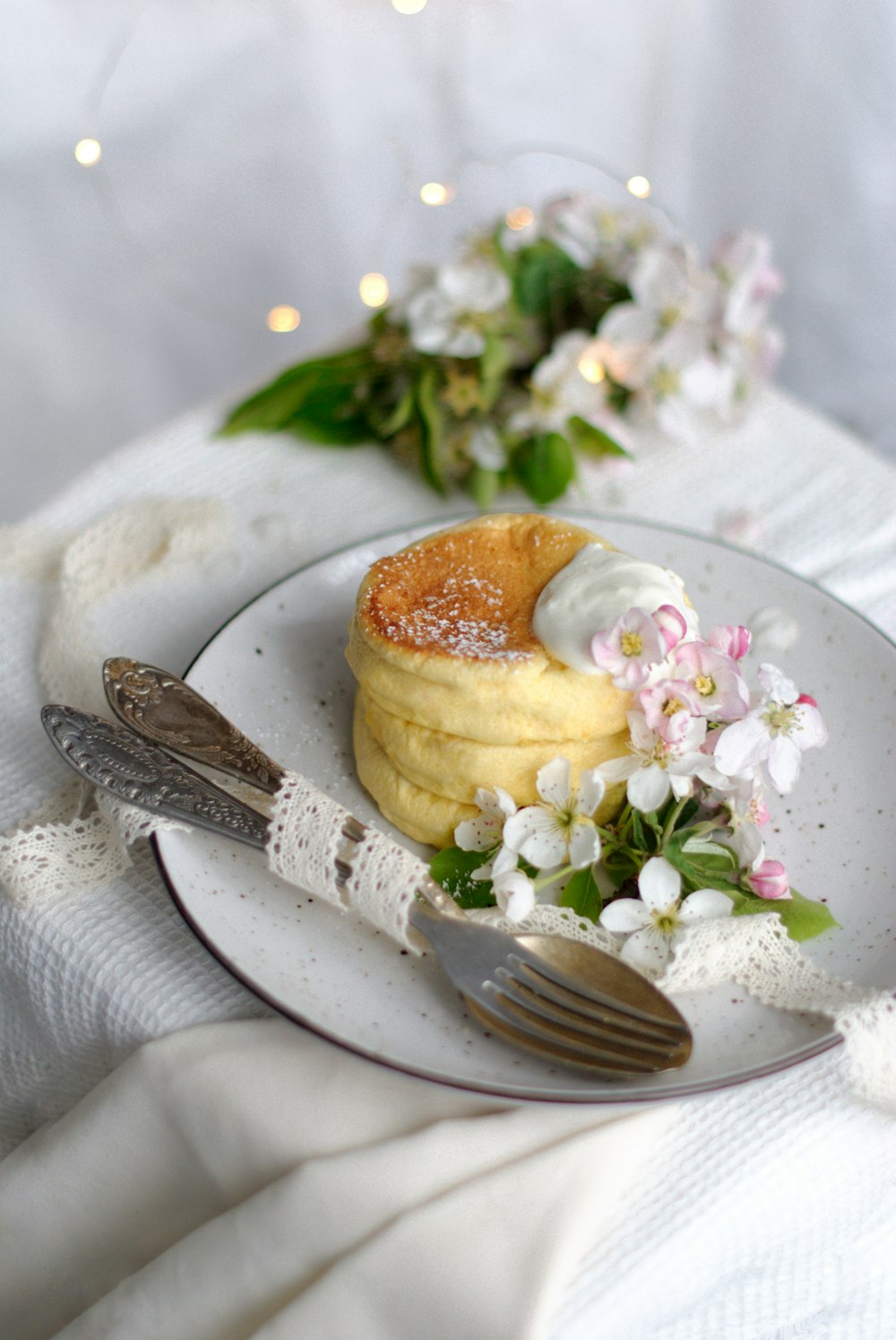 stainless steel fork beside white ceramic plate with food