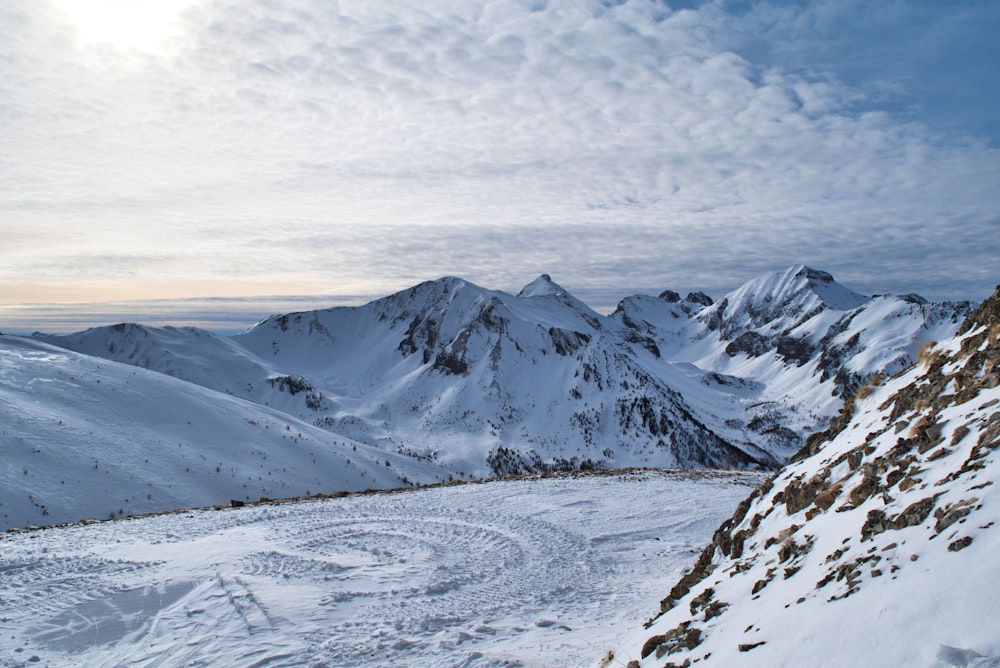 snow covered mountain under cloudy sky during daytime