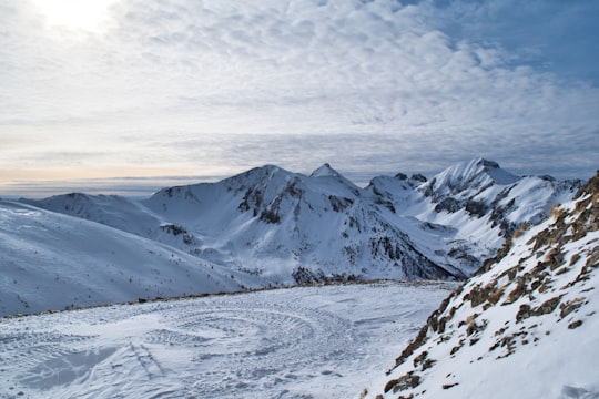 snow covered mountain under cloudy sky during daytime in Écrins National Park France