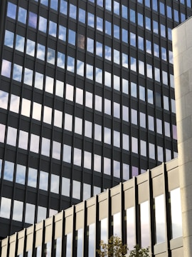 A sleek office complex with glass facades reflecting the sky.