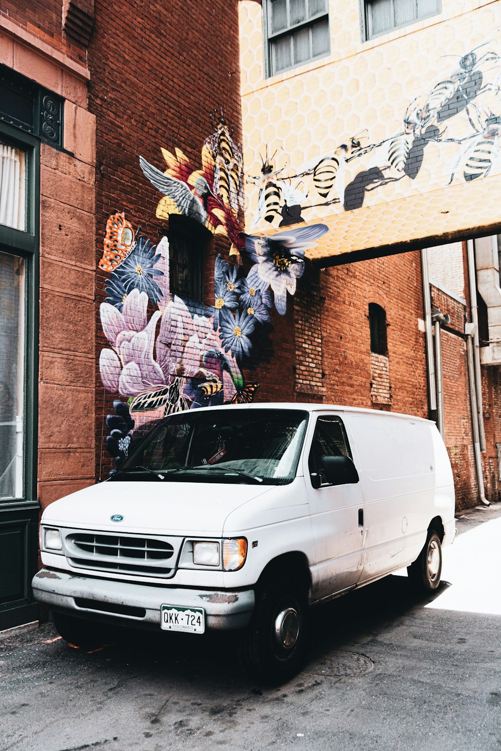 a white van parked in front of a building