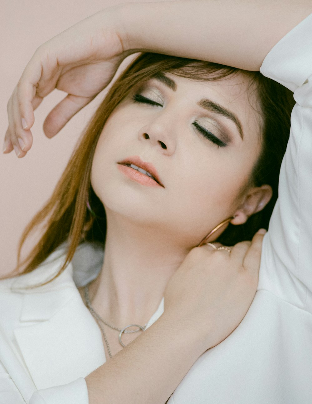 woman in white shirt with silver necklace