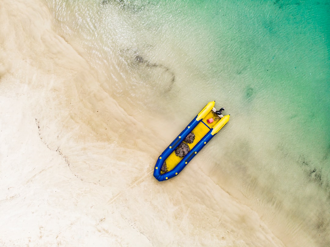 yellow and blue kayak on water