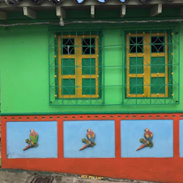 A bright and lively wall painting decorating a cozy living room.