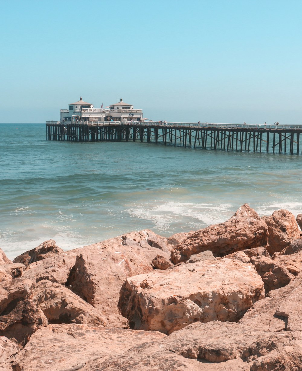 brown wooden dock on blue sea under blue sky during daytime