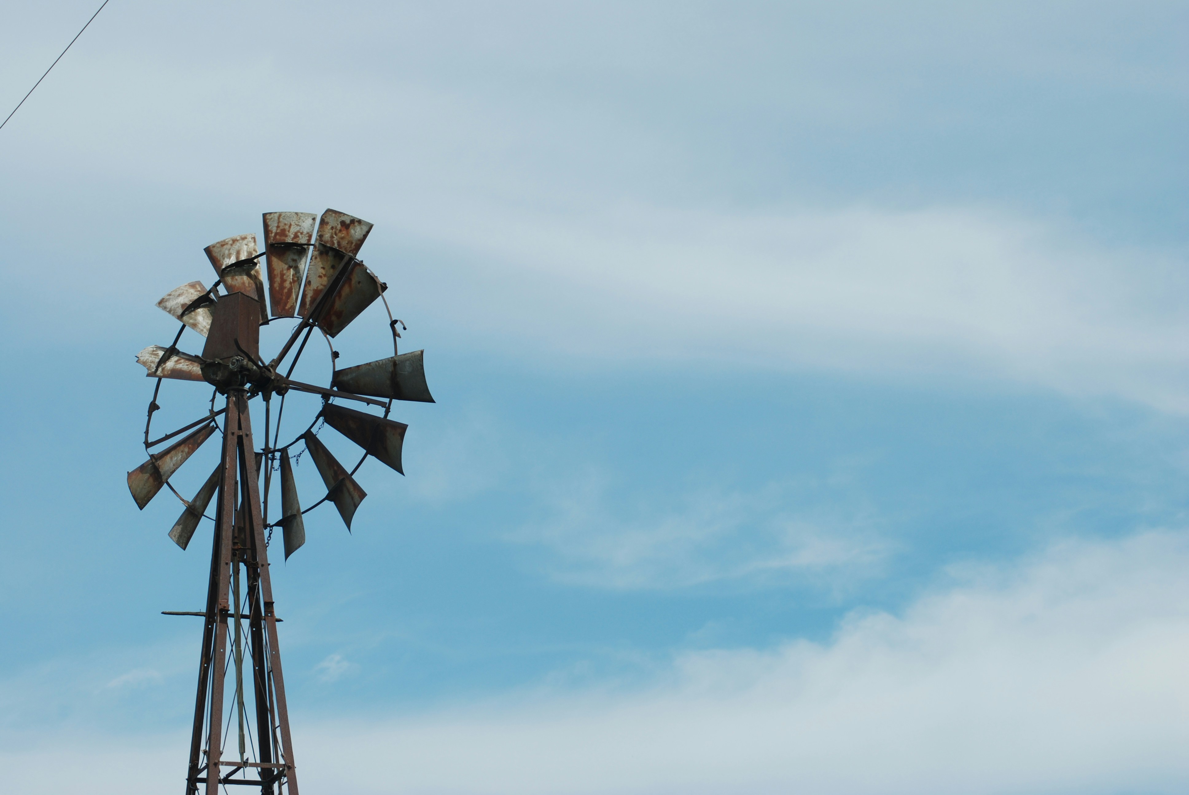 brown and white windmill under blue sky during daytime