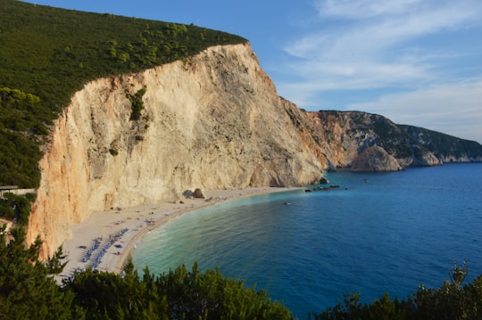 green and brown mountain beside body of water during daytime in Porto Katsiki Greece