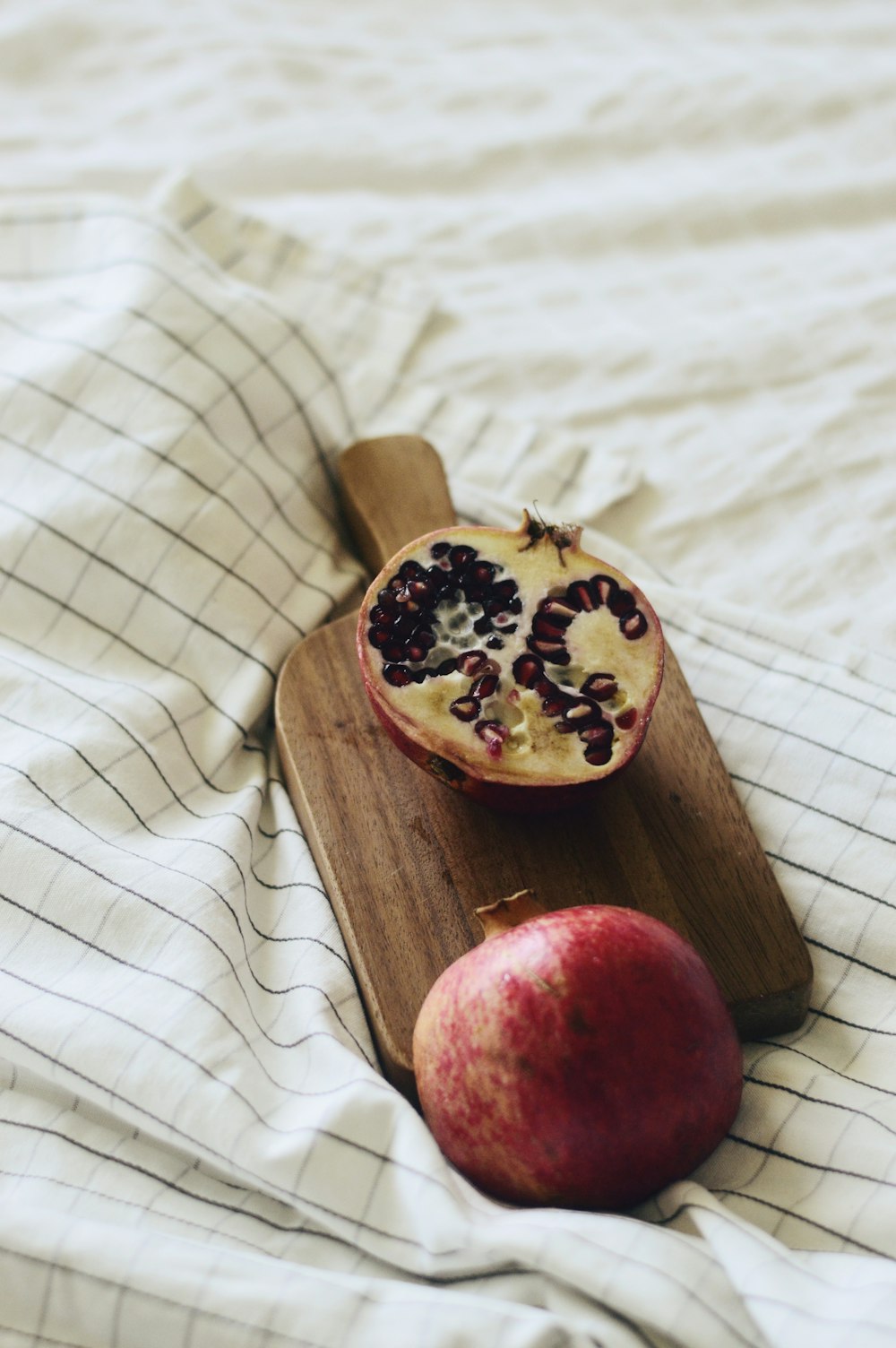 red fruit on brown wooden chopping board