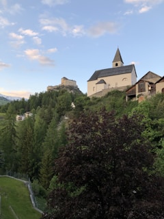 A serene image of a medieval church surrounded by nature.