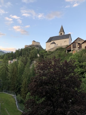A serene image of a medieval church surrounded by nature.