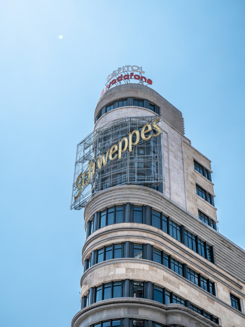 a tall building with a sign on top of it