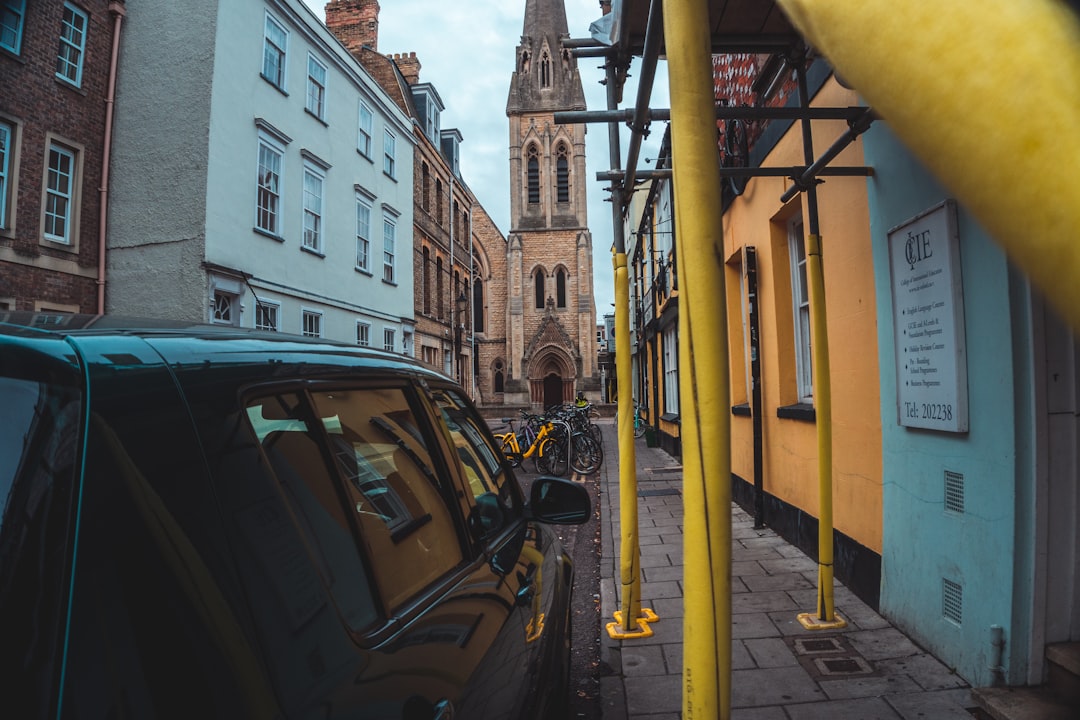 cars parked beside building during daytime