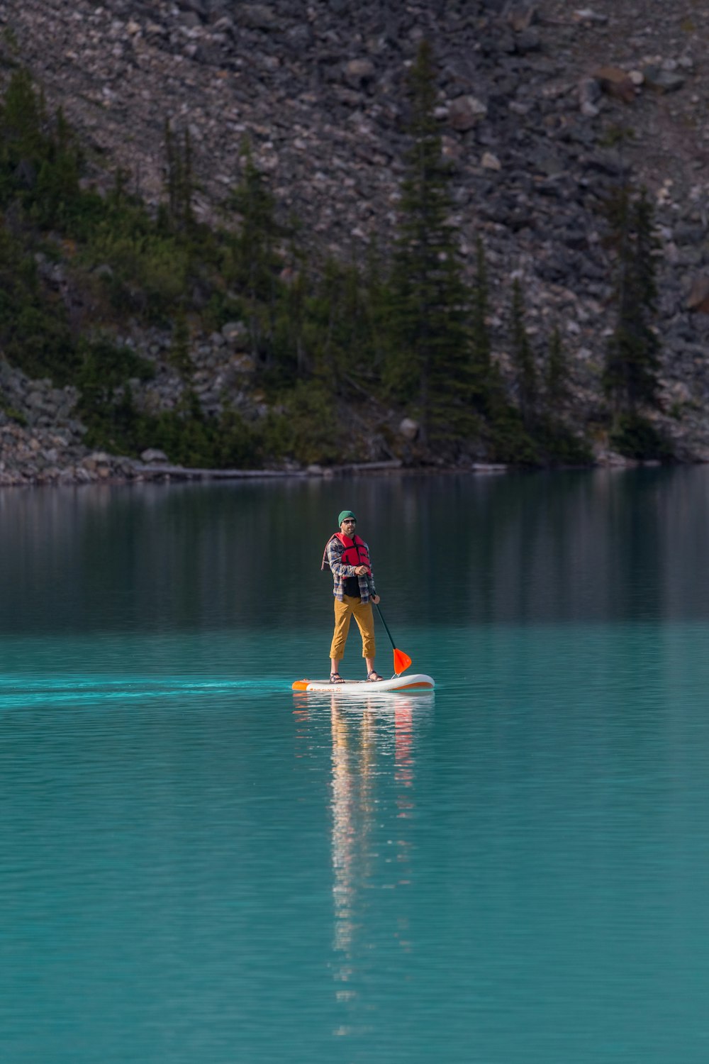 man in red shirt riding yellow kayak on blue water during daytime