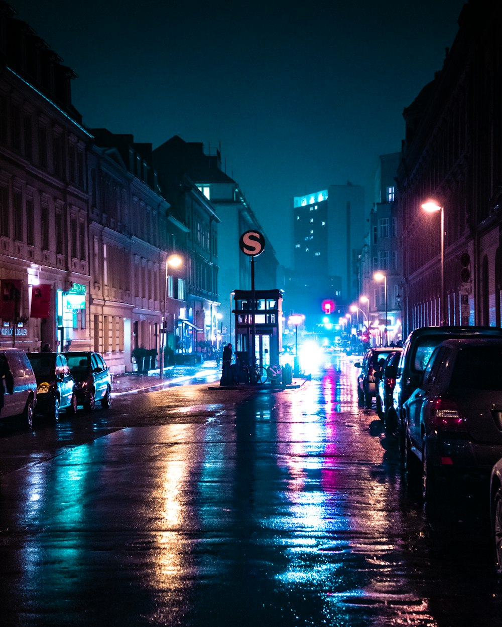 cars parked on side of the road during night time