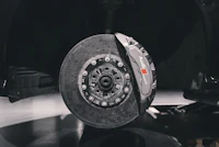Apex Race-Spec front brake pads — carbon-ceramic rotor and caliper hero shot