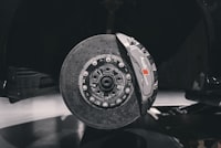 Apex Race-Spec front brake pads — carbon-ceramic rotor and caliper hero shot