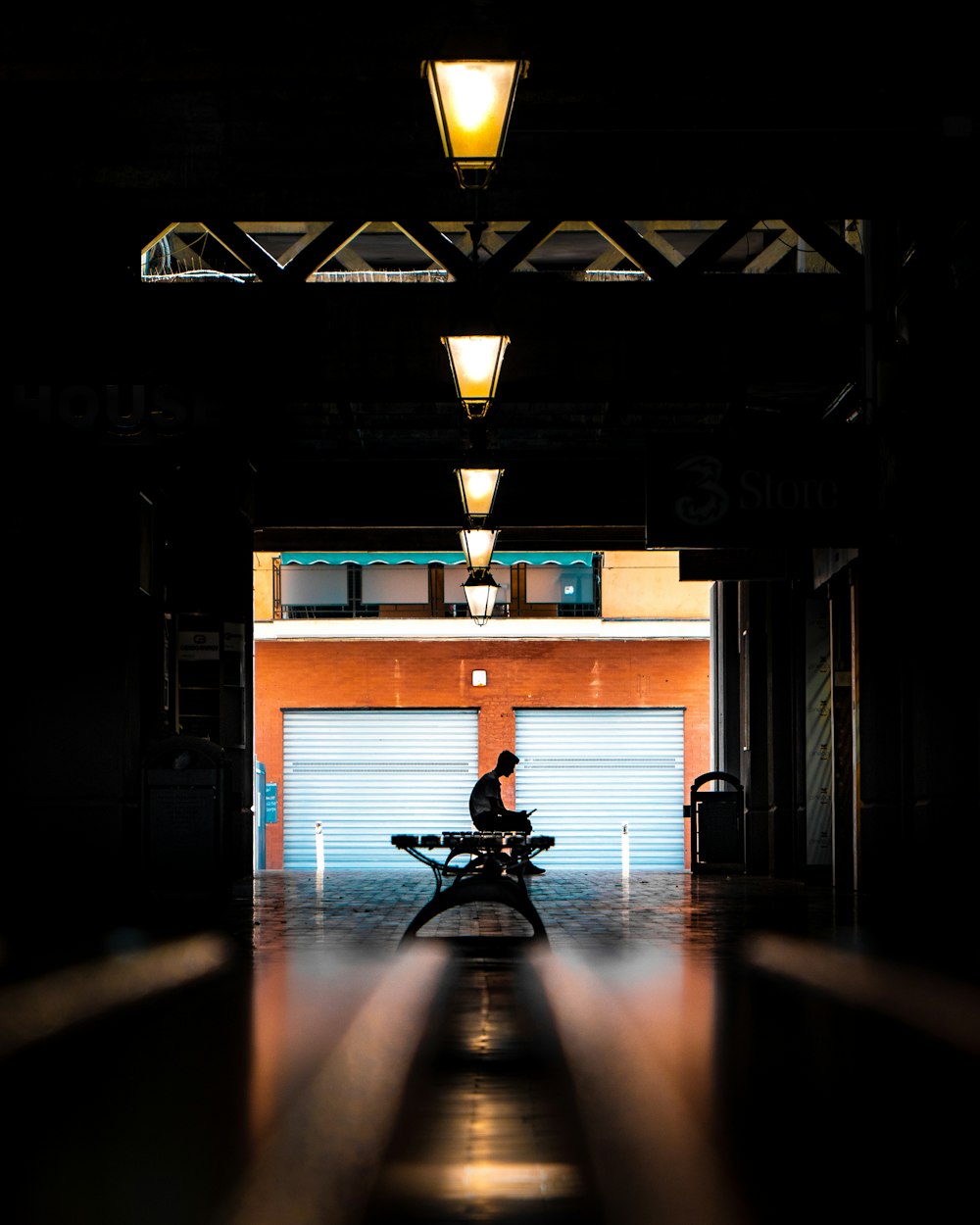 silhouette of person sitting on bench