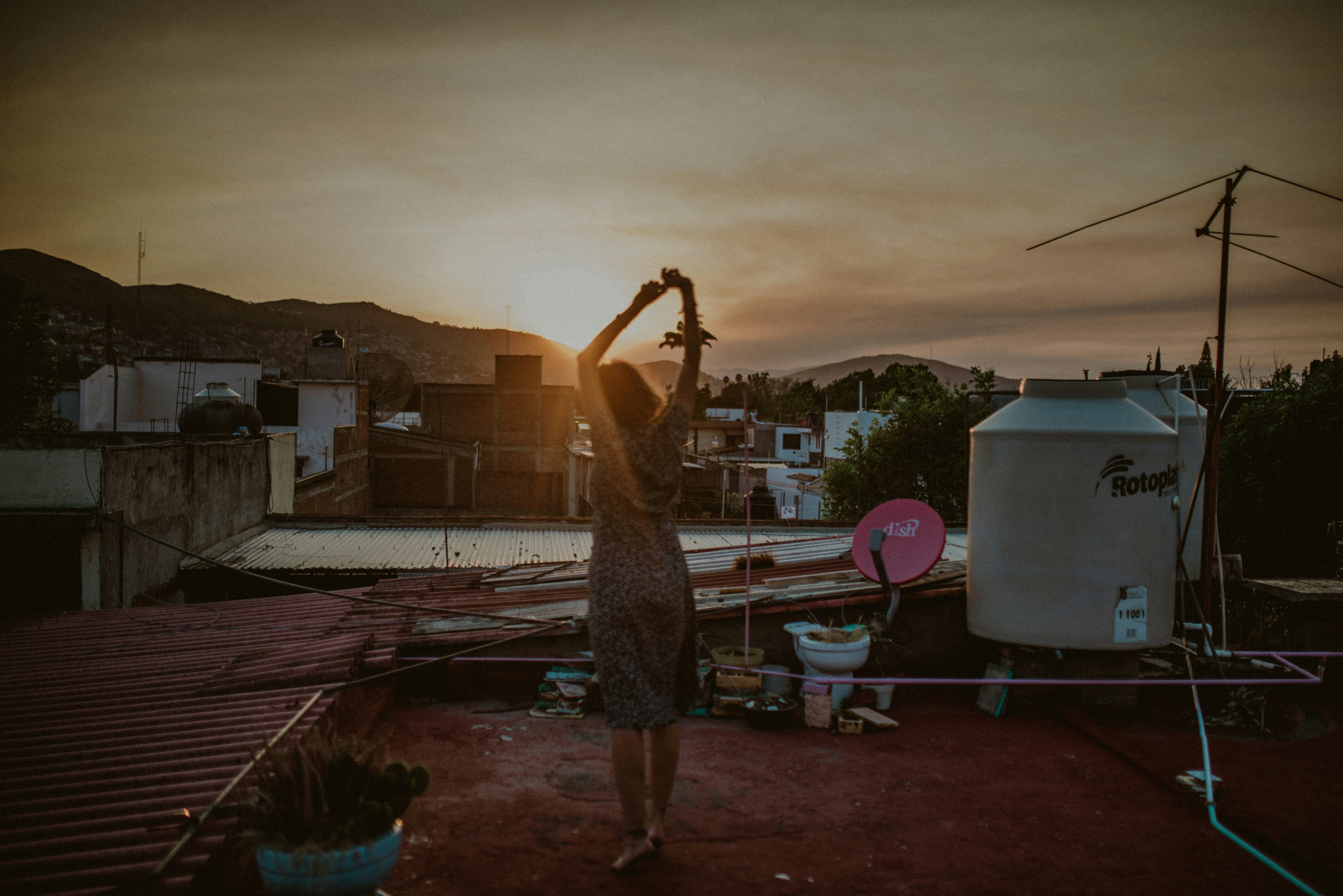 woman in black and white dress standing on blue and white plaid textile during daytime