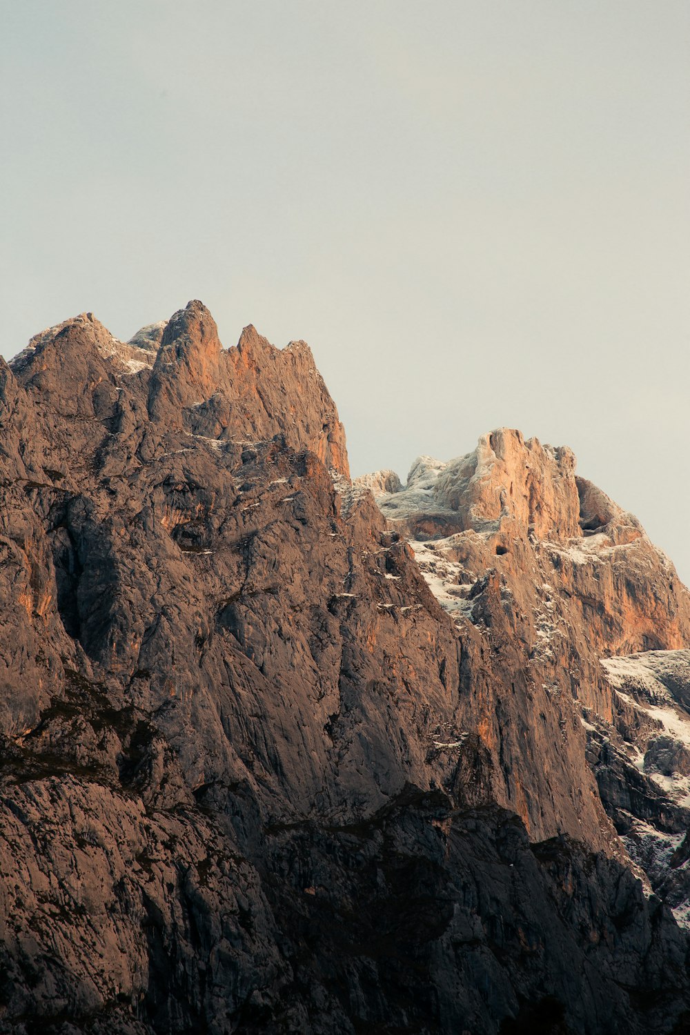 brown rocky mountain under white sky during daytime