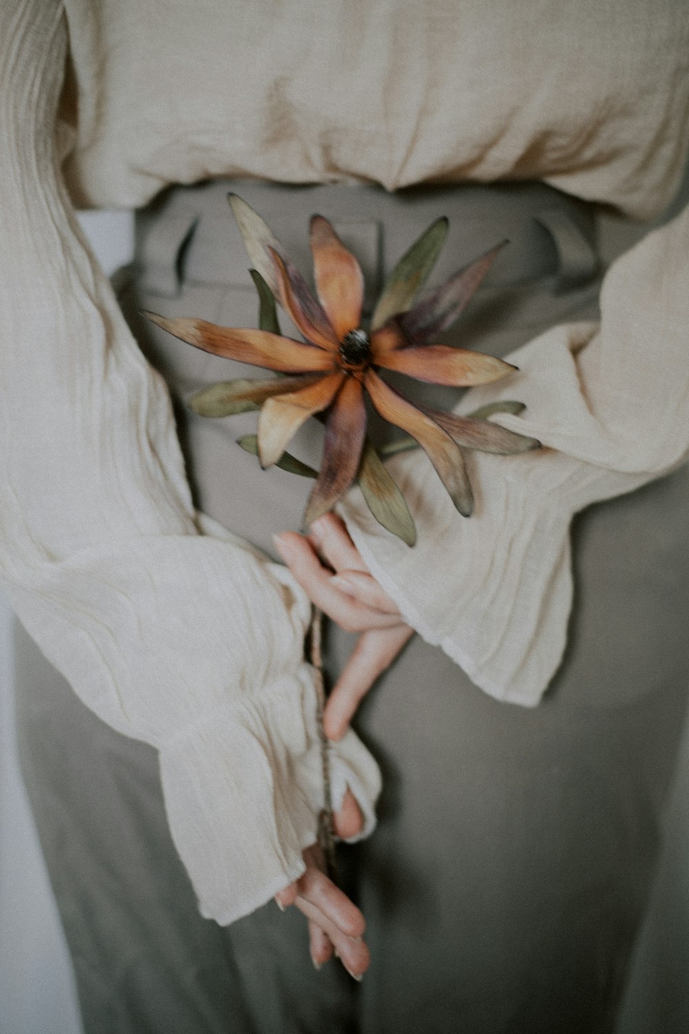 white textile with brown flower accent