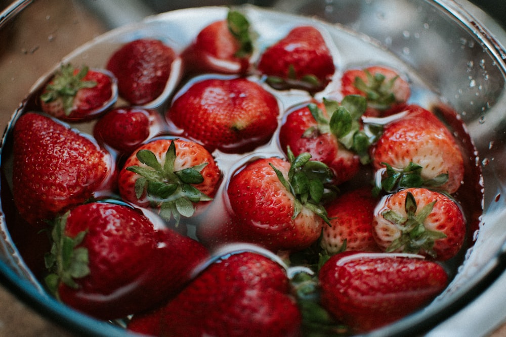 strawberries in clear glass bowl