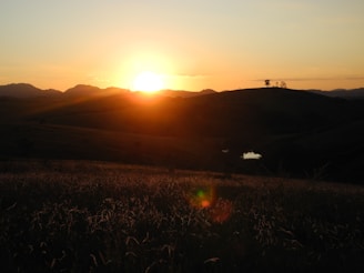 A serene landscape showcasing a vibrant sunset over rolling hills.